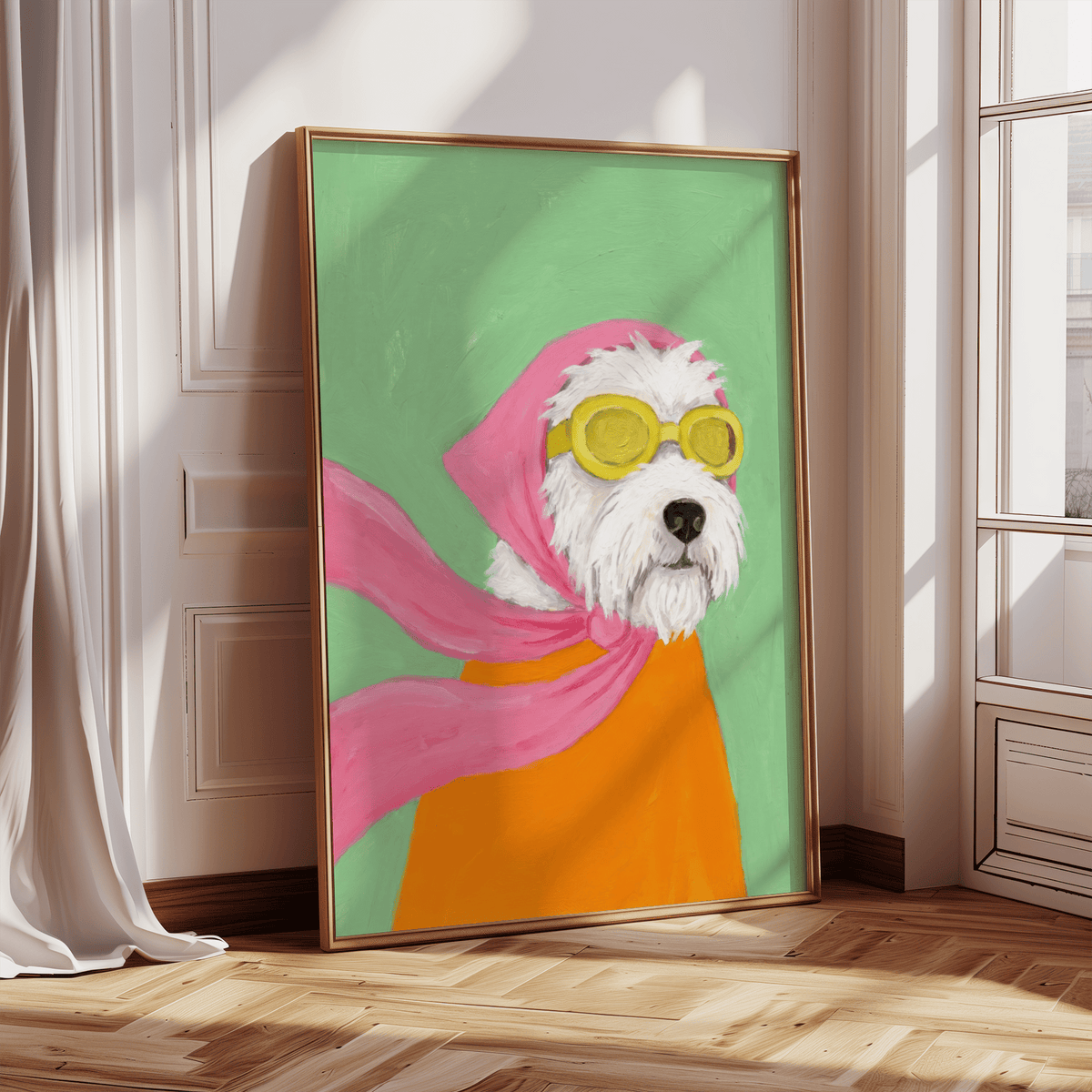 Print leaning on a floor depicting a dog with pink scarf and yellow aviator goggles in natural light