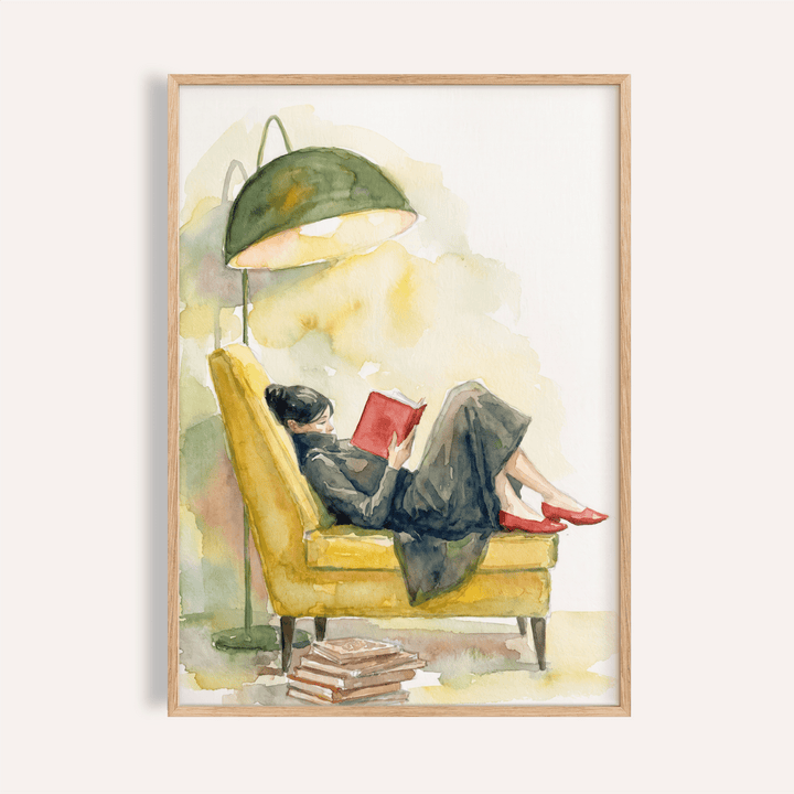 Woman Reading In Armchair Print of a woman in a yellow armchair with a green lamp and stack of books