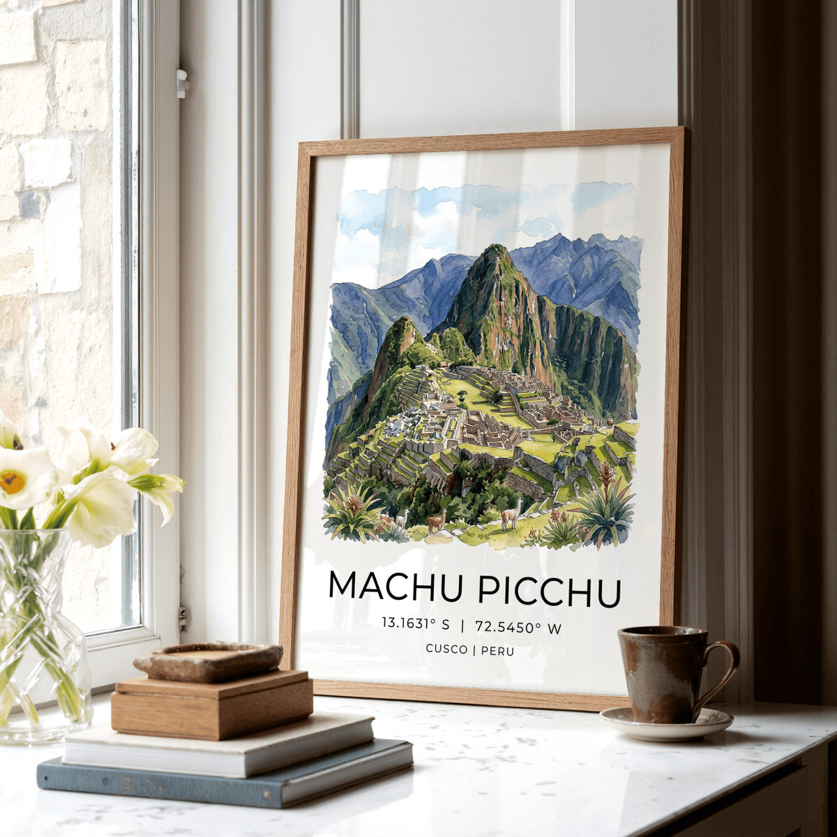 Machu Picchu art print leaning on a kitchen windowsill next to books and a cup