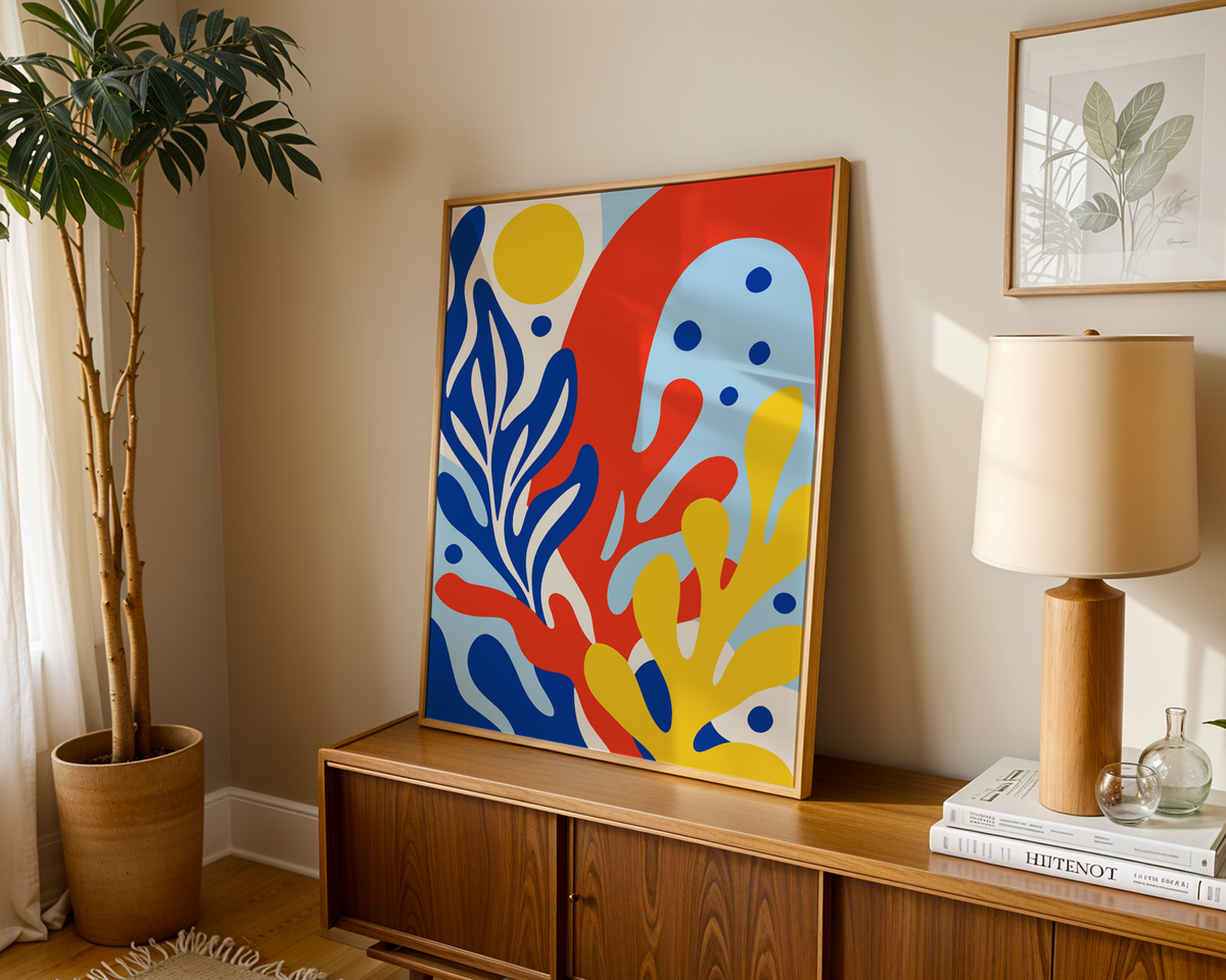 Primary colours print of coral shapes leaning on a wooden sideboard in a warm living room