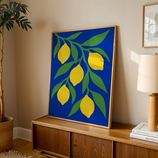 Lemon tree print on deep blue leaning on a wooden sideboard in a warm living room