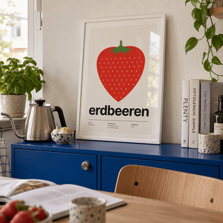 Single big strawberry print in a kitchen cabinet against a cobalt wall