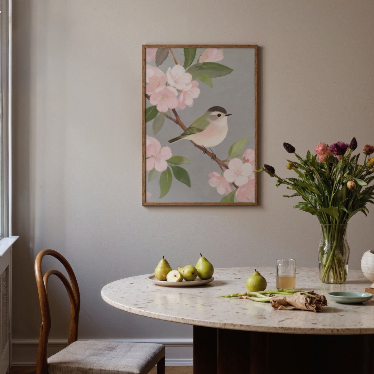 Botanical Bird Wall Art of a small bird on a branch with pink blossoms above a dining table with pears and a vase