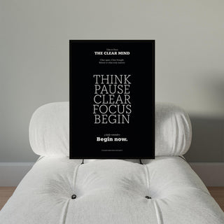 Motivational Quote Prints framed print with white text on black background on a white tufted chair