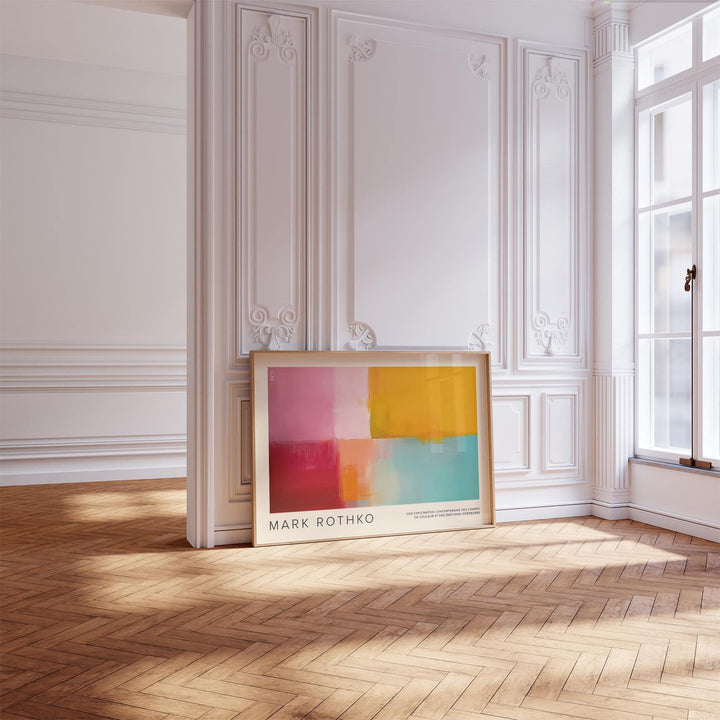 Colorful Abstract Art print with pink orange and blue blocks leaning on ornate white wall in bright room
