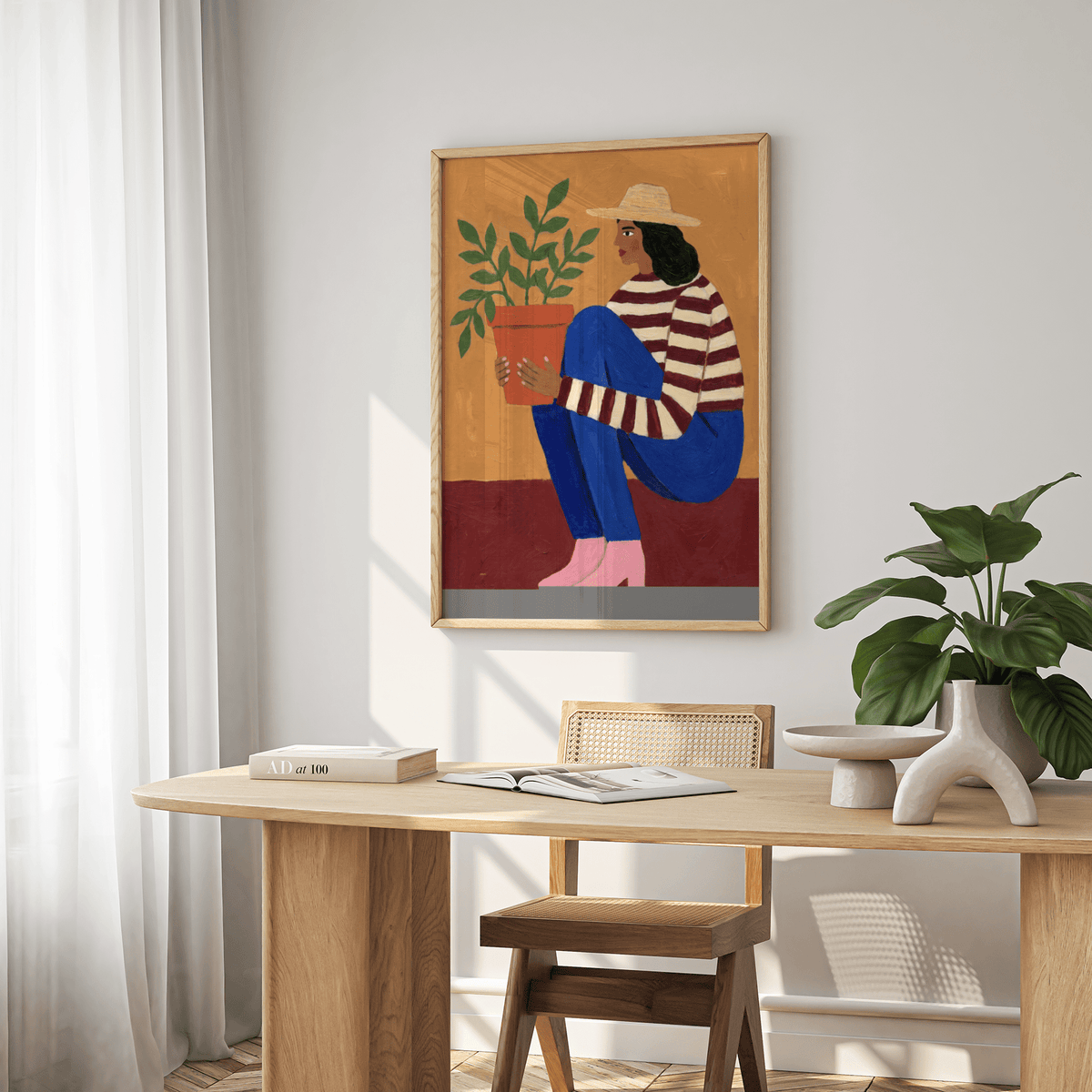 Woman Plant wall art of a woman holding a potted plant in earthy tones above a dining table with a large green plant