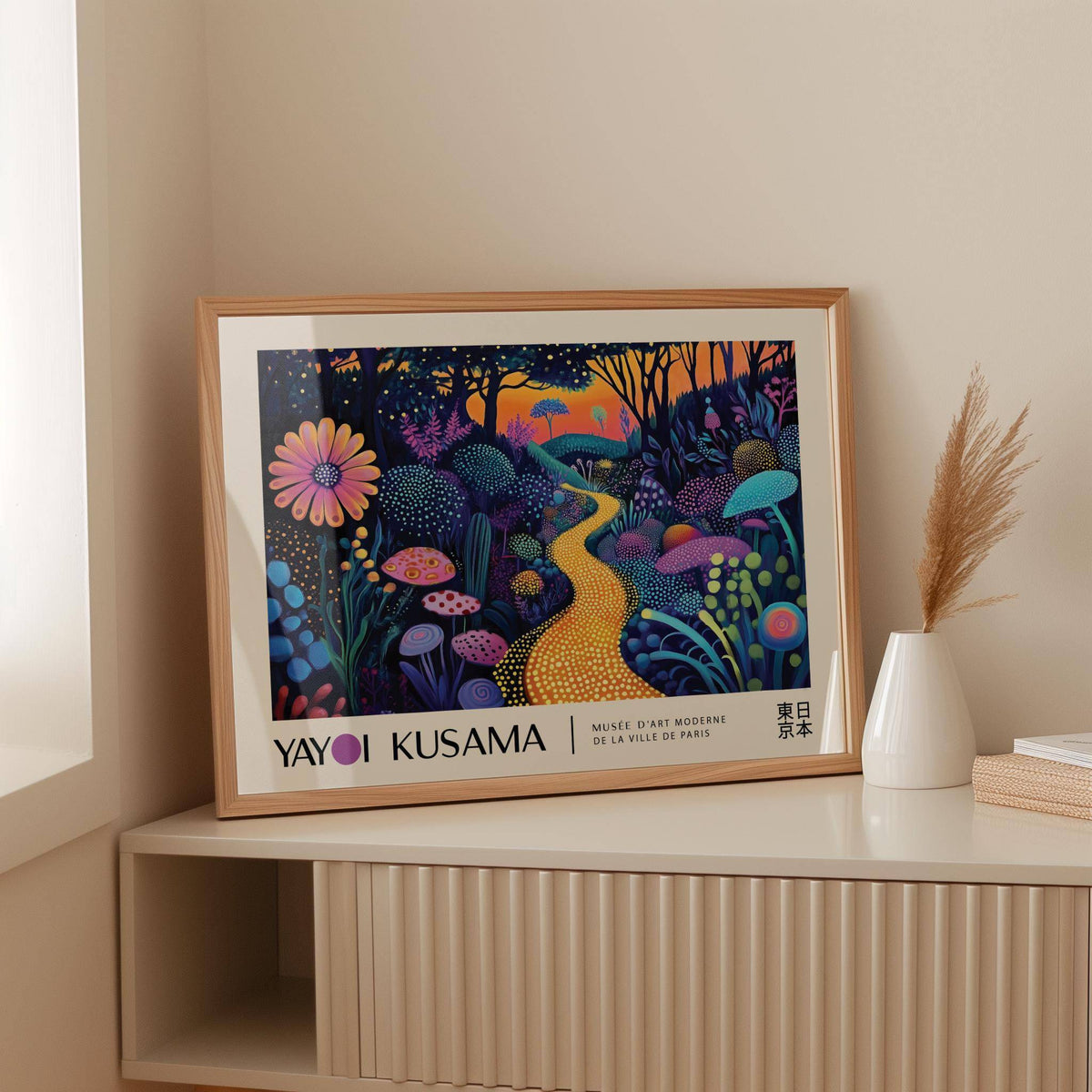 Framed Mystical Prints artwork of a glowing yellow path with colourful flora leaning on a cream sideboard with a white vase
