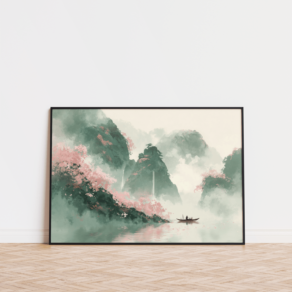 Mountain landscape art print with misty green mountains and pink foliage leaning on a wooden floor