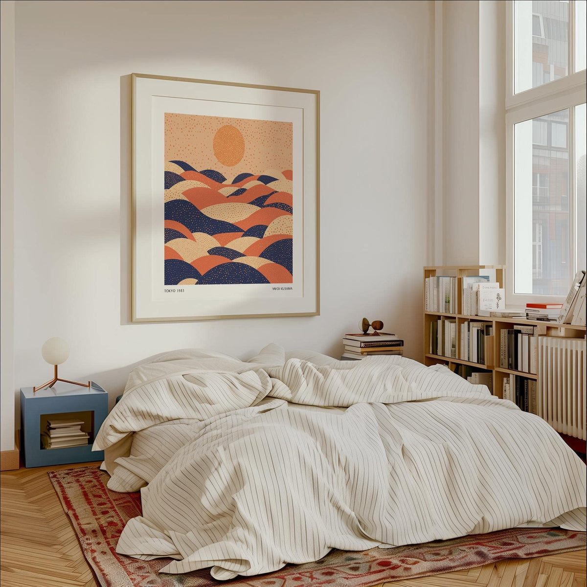 Abstract wall art colourful with orange, navy and cream hills above a white bedside table in a bedroom