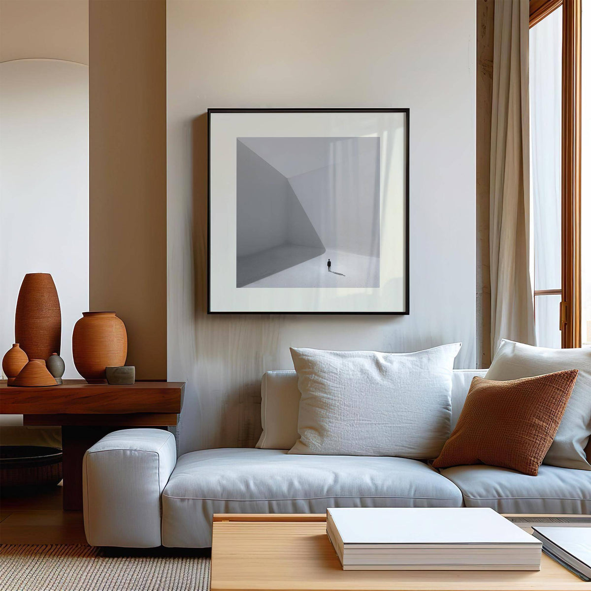 Square Art Prints of a solitary man minimalist photographic print in greys framed above a white sofa with cushions