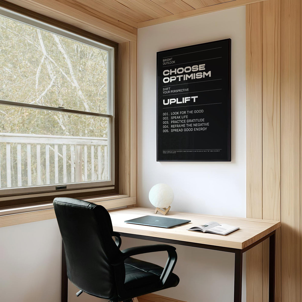 Affirmation Print in black and white typography hanging above a desk with a black chair