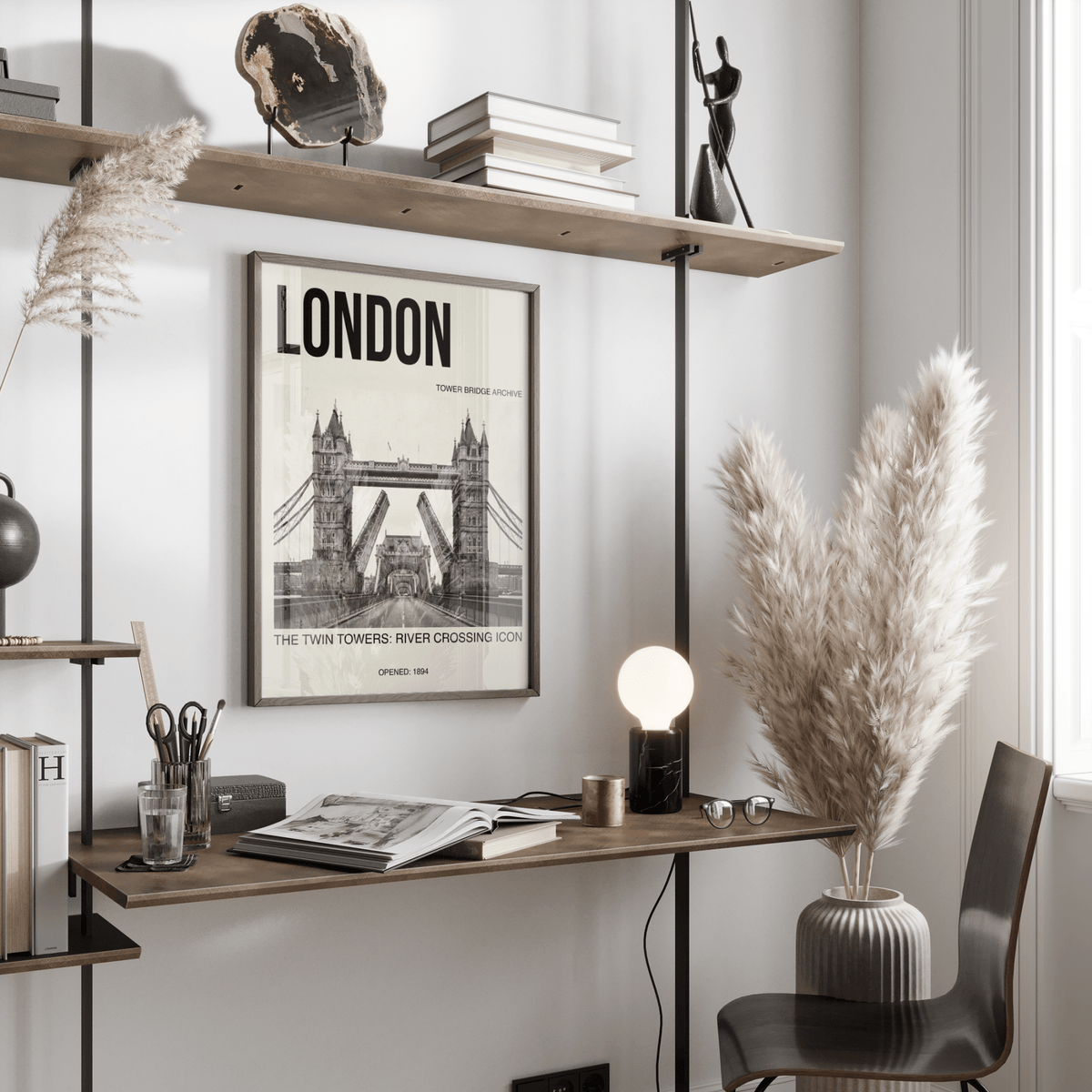Tower Bridge art print with photographic and typographic details above a desk with books and a lamp