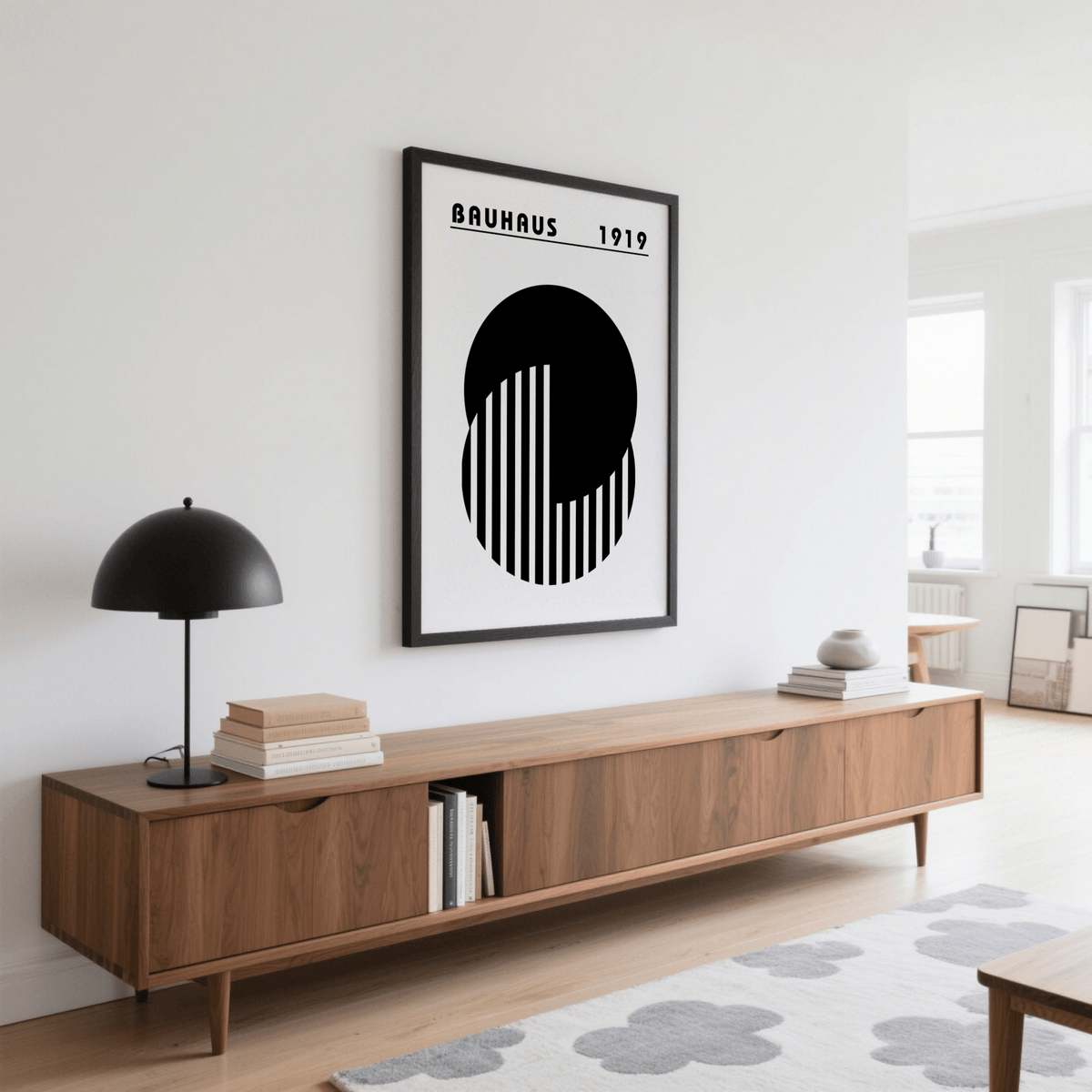 Abstract Minimal Art framed print with black geometric circles above a wooden sideboard with a lamp