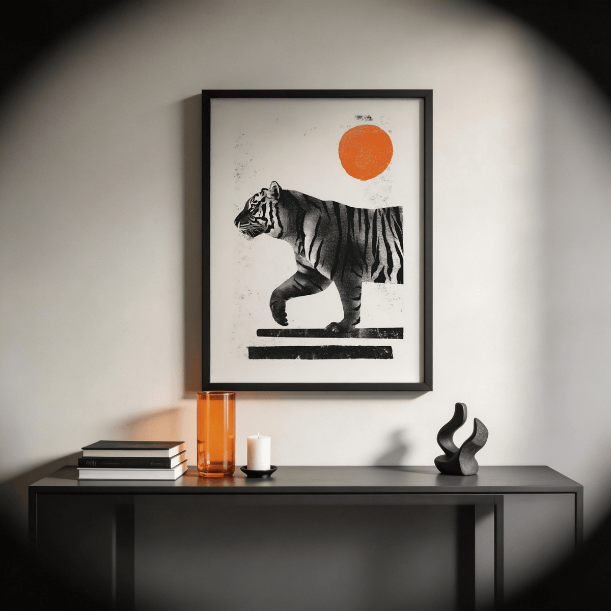 Indian Tiger Print framed print with a black frame and orange sun above a black console with orange vase and sculpture