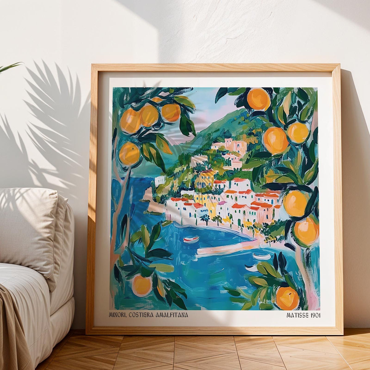 Amalfi wall art print reclining on floor with coastal village in blues and oranges near a beige sofa