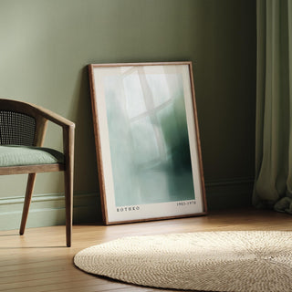 Rothko print leaning on floor with soft abstract shades of green and blue beside a chair