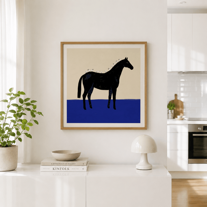 Black Horse wall art in minimalist style with black horse and white birds above a kitchen sideboard with a plant