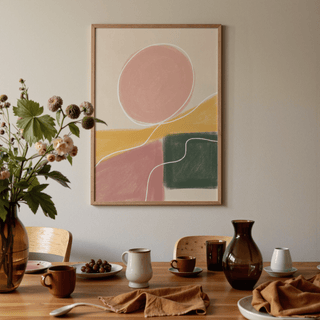 Modern Abstract Print hanging above dining table with brown ceramics and a vase with flowers