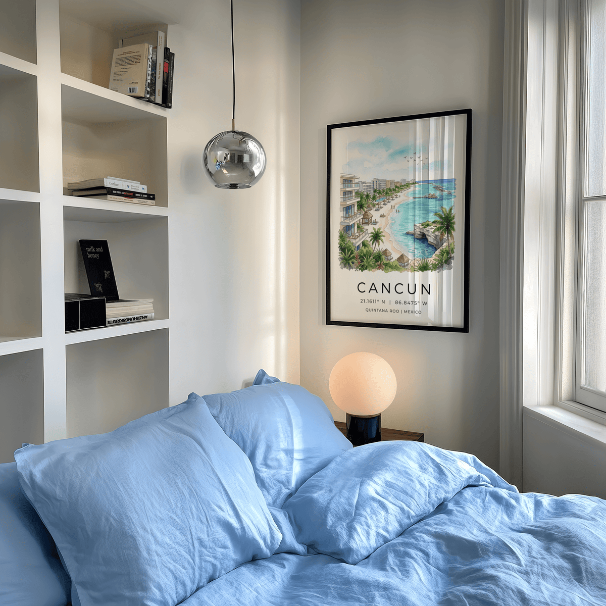 Cancun Beach Art Print framed on wall above a blue cushioned bed with a round lamp nearby