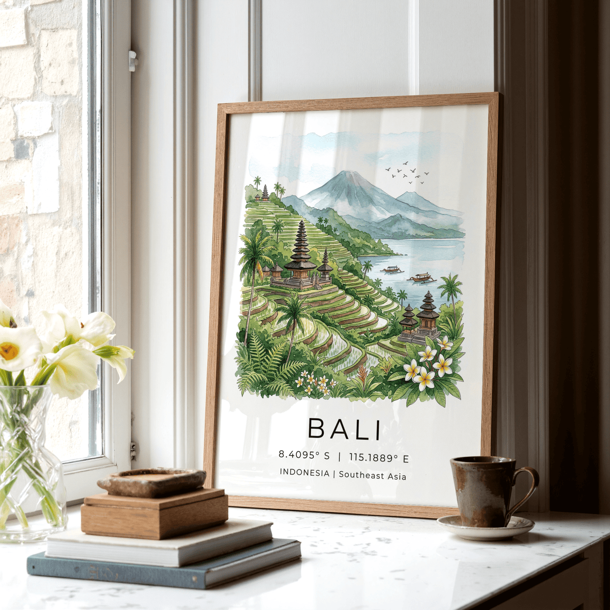 Print leaning on a shelf of Balinese rice terraces in green and blue with a floral arrangement nearby