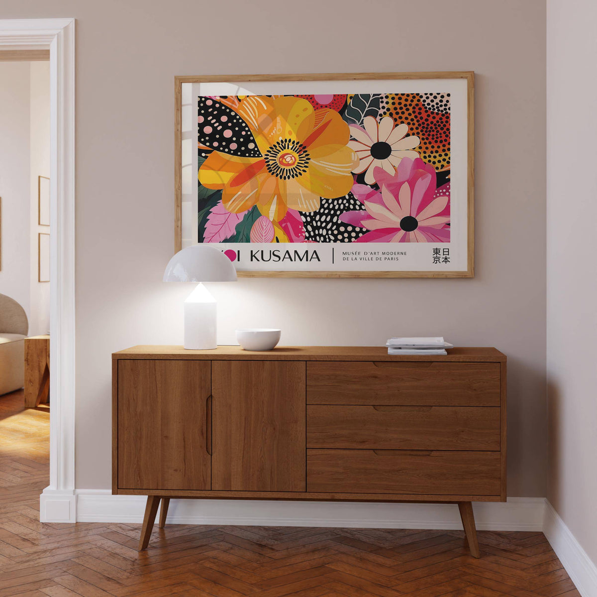 Floral Poster Art framed print of bright abstract flowers in bold colours above a wooden sideboard with lamp