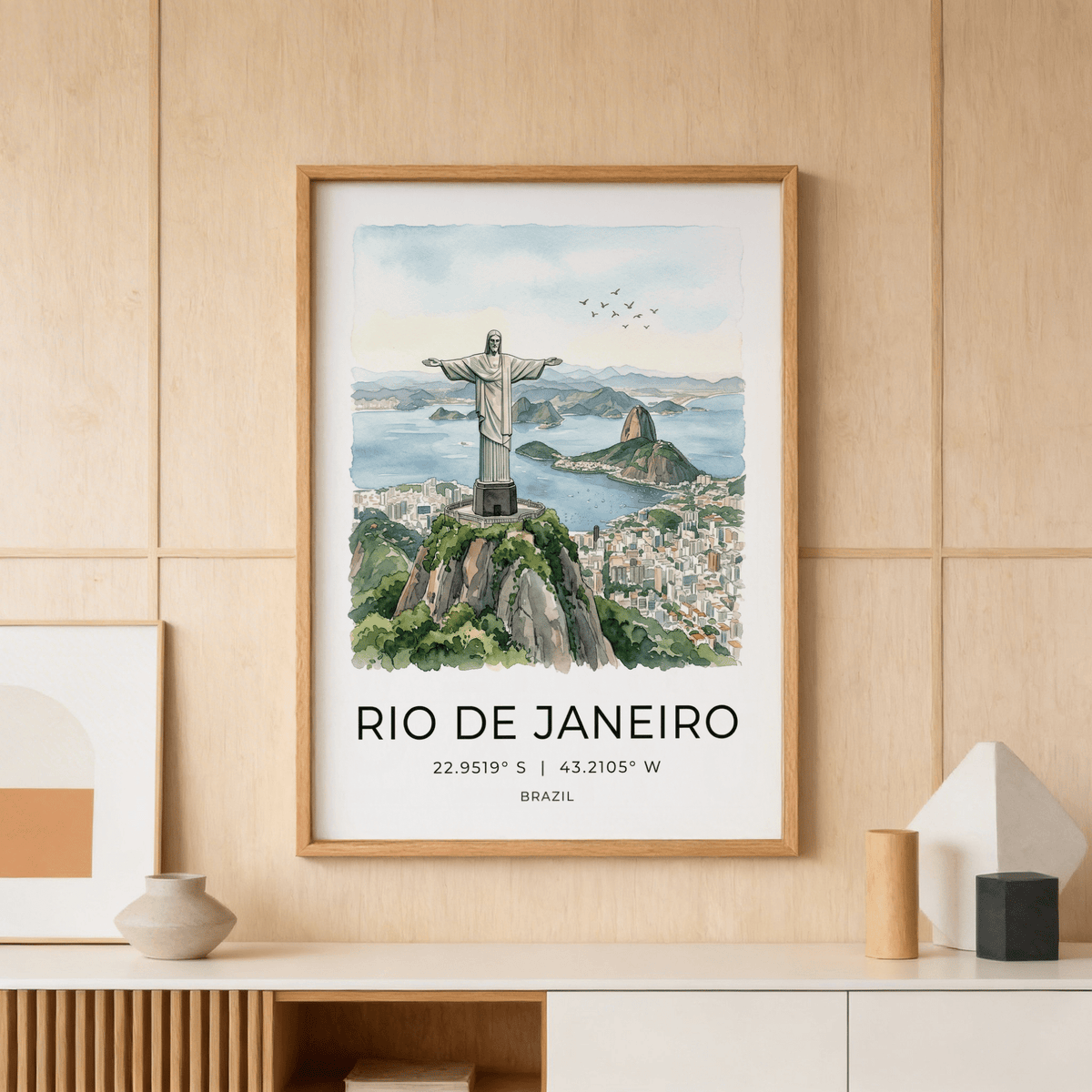 Framed Cristo Redentor Poster of the statue over Rio with muted blue and green watercolour tones above a shelf