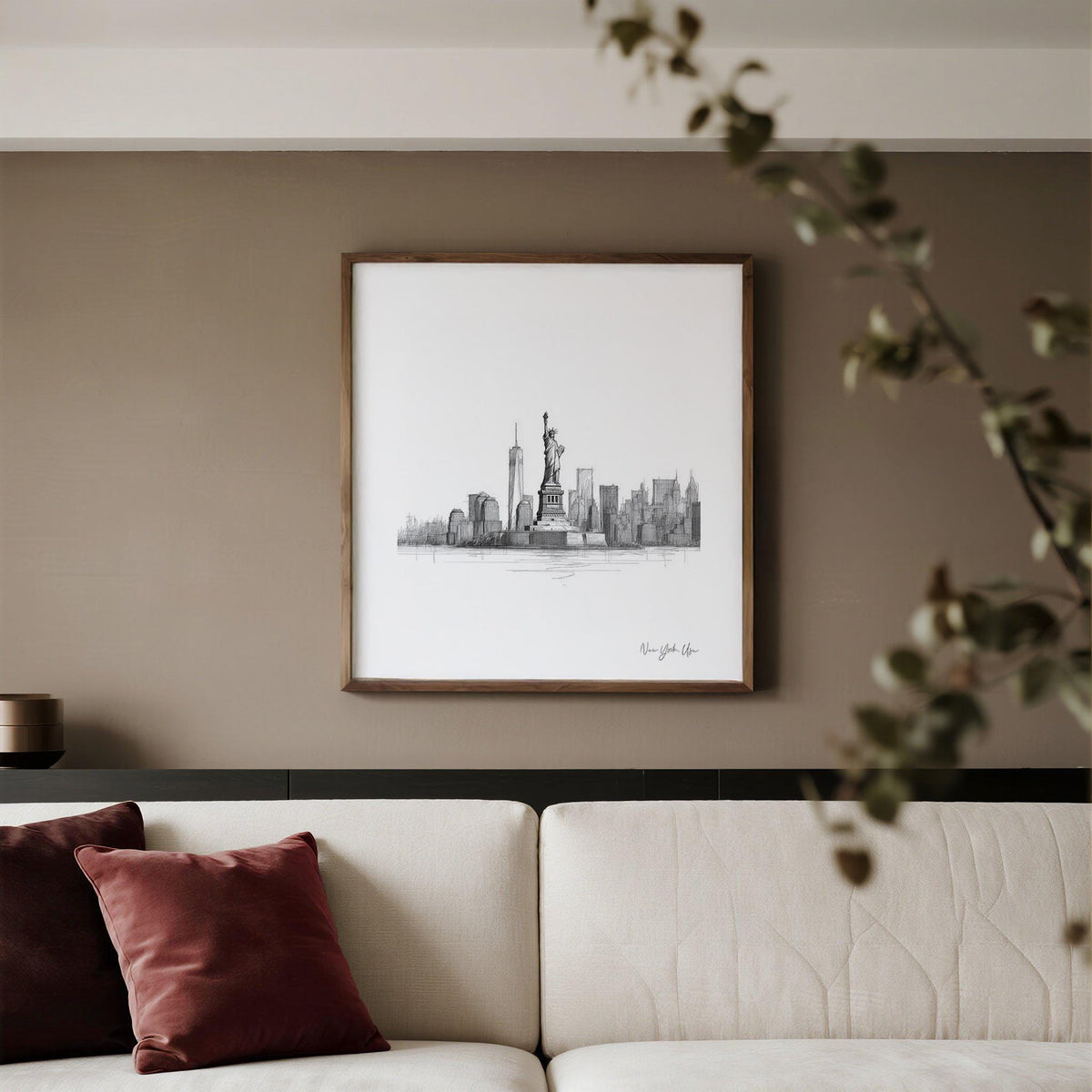 Statue of Liberty print in minimalist line-art style on a living room wall above a sofa with cushions