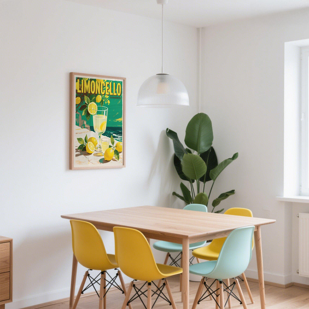 Drinks wall art showing limoncello drink with lemons in a vintage style in a dining room with yellow and blue chairs