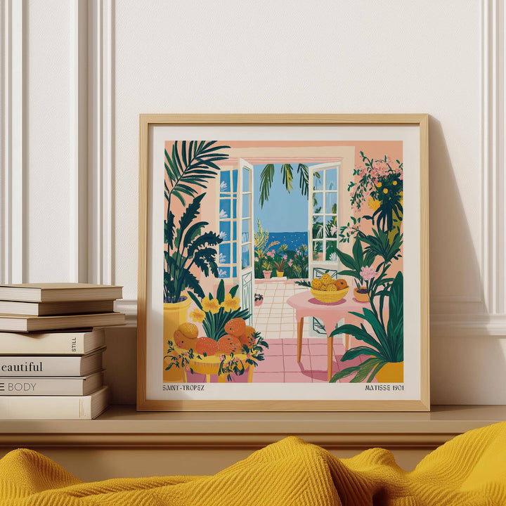 Coastal wall art of open doors with sea view and tropical plants near a pink table on a shelf