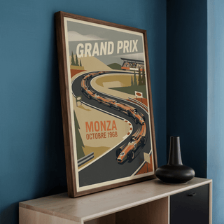 Framed Monza Grand Prix art print with retro racing cars leaning on a sideboard next to a black vase