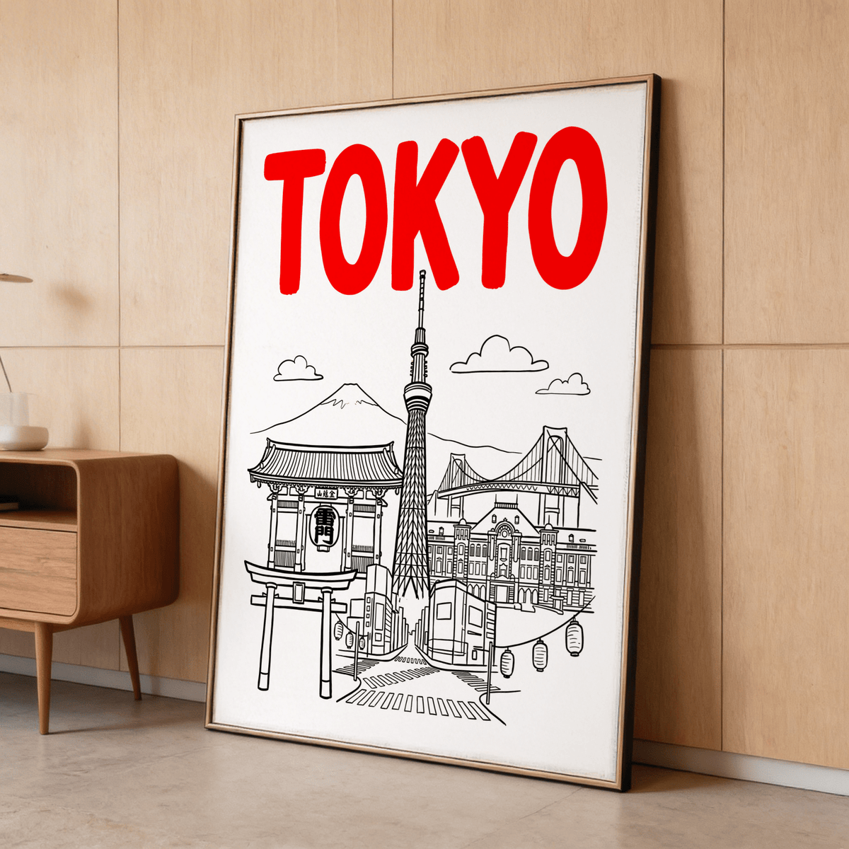 Print leaning of Tokyo City Wall Art showing landmark line-art with bold red typography beside a wooden cabinet