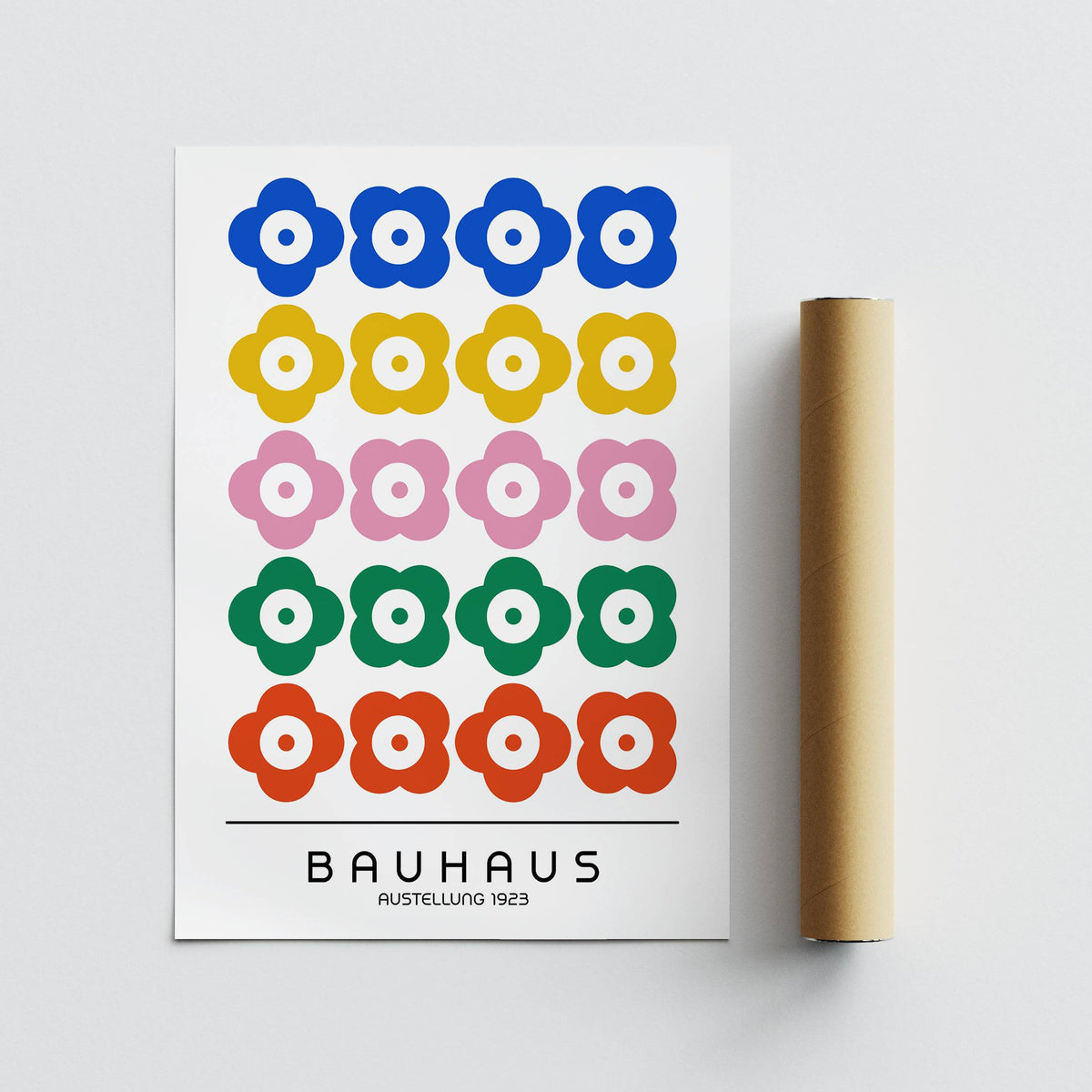 Bauhaus print design of colourful stylised flowers with a packaging tube on a grey surface