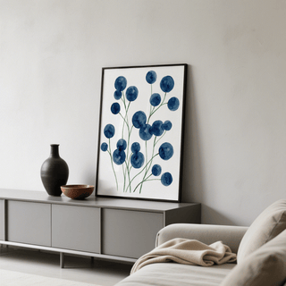 Print leaning on a shelf of blue watercolor botanical flowers with green stems and a dark vase nearby