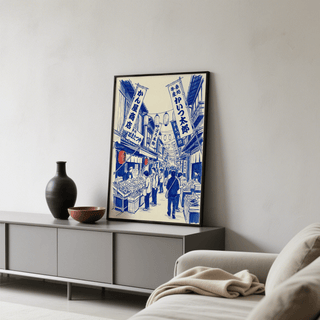 Japanese Market Art Print leaning on a grey sideboard next to a black vase in a living room