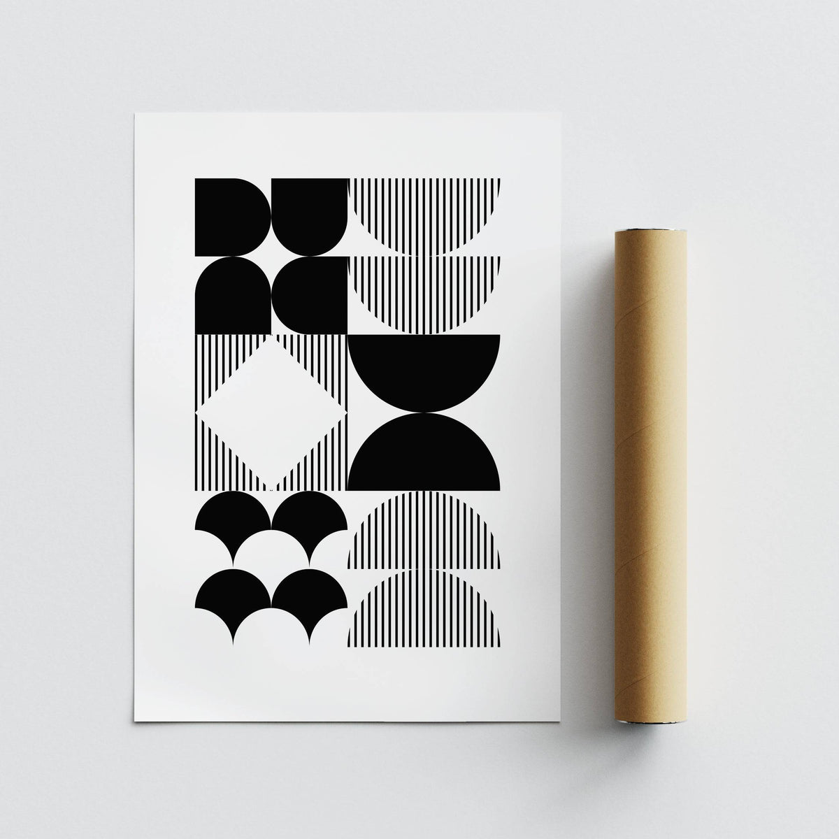 Black and White Geometric Wall Art with black and white minimalist shapes and a packaging tube beside it