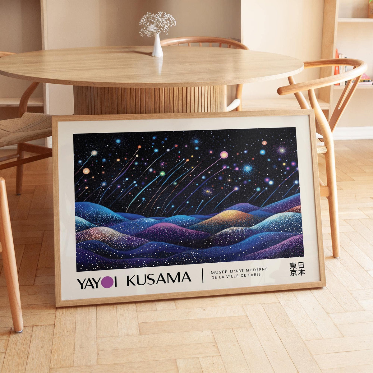 Landscape prints leaning on floor showing shooting stars over colourful hills under starry sky