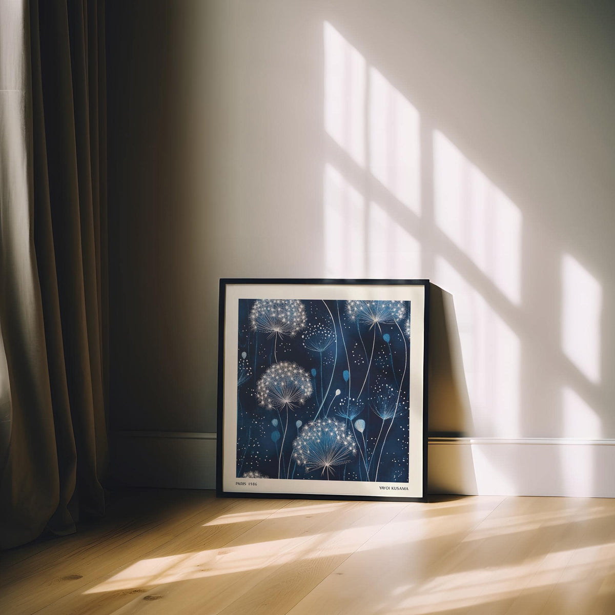Blue art work leaning on wooden floor with dandelion seed heads on deep blue background and shadows on wall