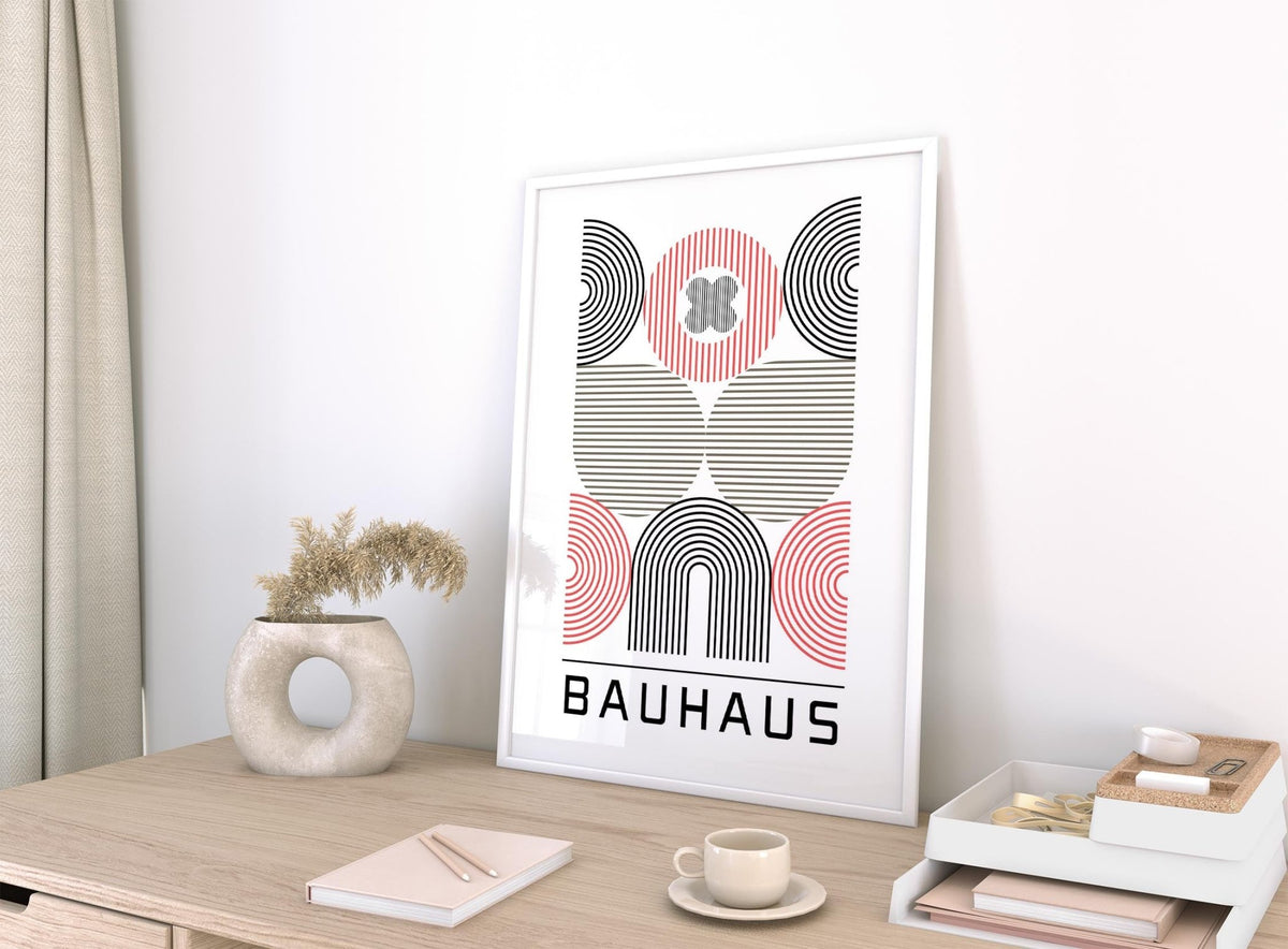 Framed Wall Art for Home Office with abstract geometric shapes and Bauhaus text on desk with vase