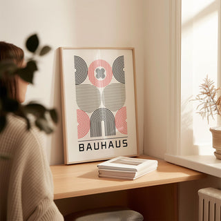 Wall Art for Home Office leaning print of abstract geometric shapes in red black and grey near a window with plant