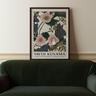 Framed Pink Wall Art for Bedroom showing pink flowers with berries above a dark green sofa