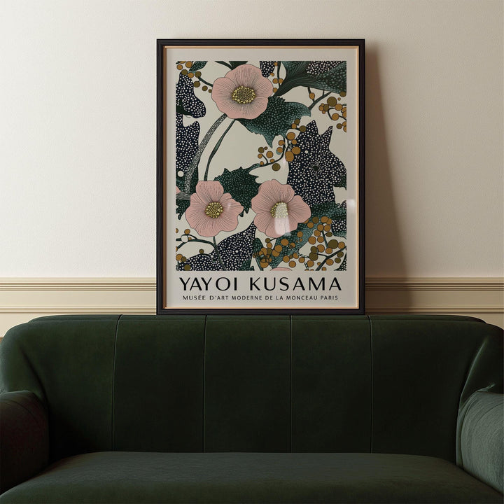 Framed Pink Wall Art for Bedroom showing pink flowers with berries above a dark green sofa