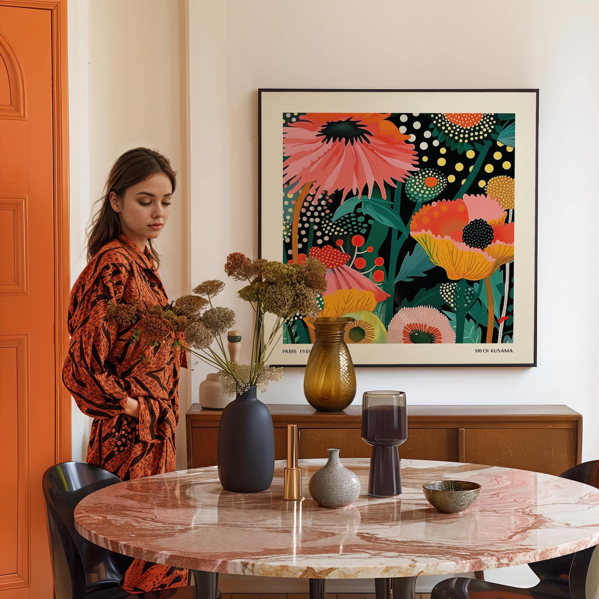Framed floral wall hanging with colourful stylised flowers above a midcentury sideboard in a dining room