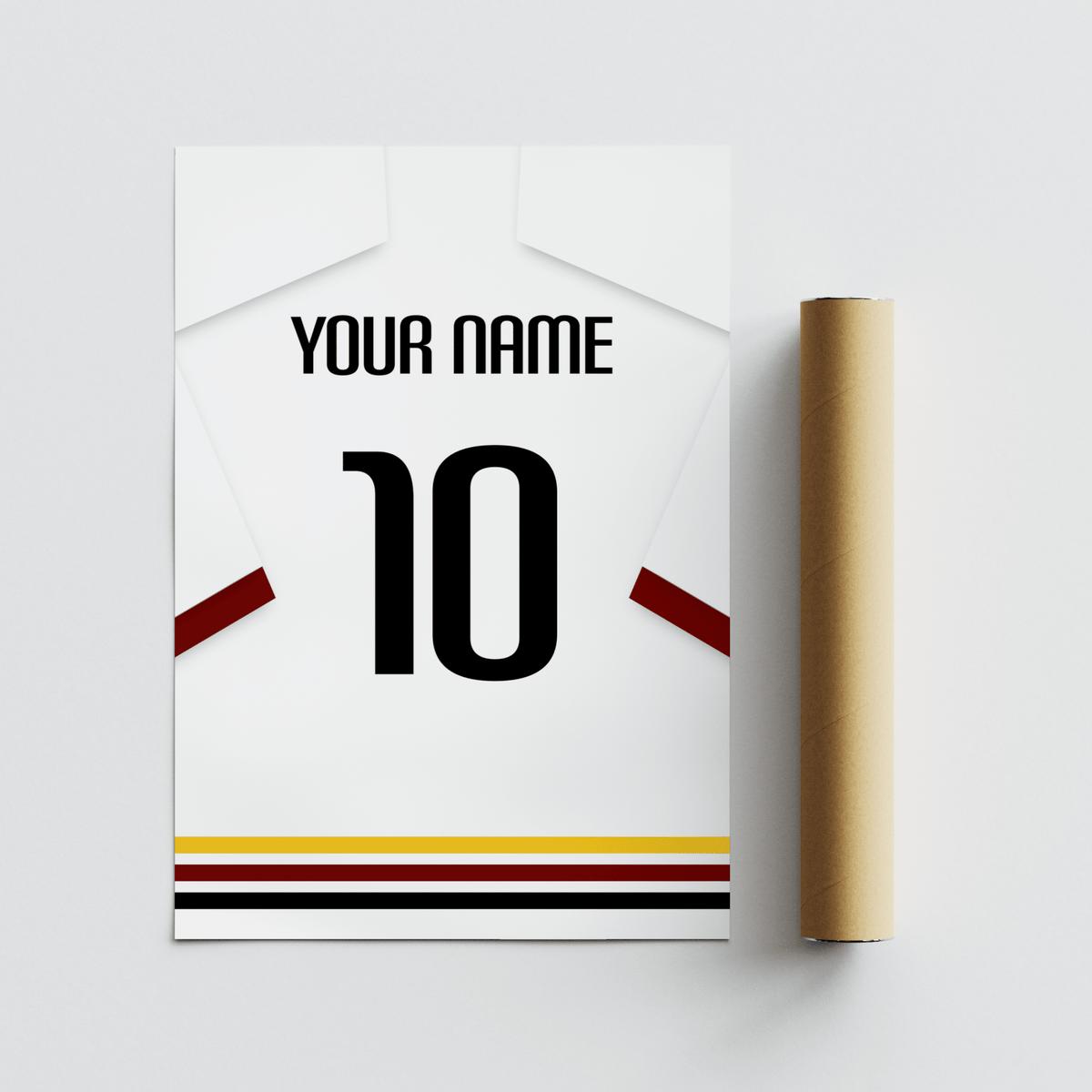 Football shirt poster in white with black red and gold hem stripes with a rolled packaging tube on a grey surface