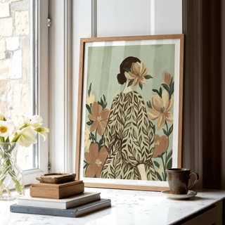 Print leaning on a shelf with woman with flowers in muted green and brown tones with a cup nearby