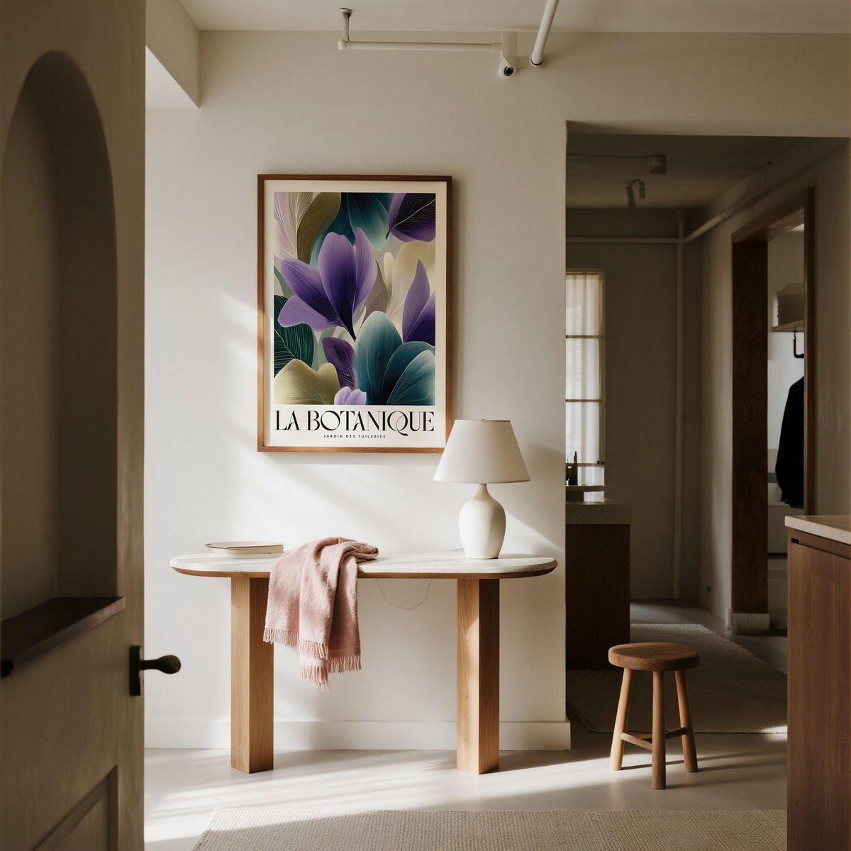 Plant poster with violet flower petals above a wooden console table with a lamp in a beige hallway