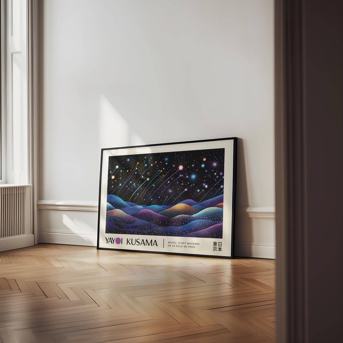 Landscape prints leaning against a white wall on a wood floor under natural light
