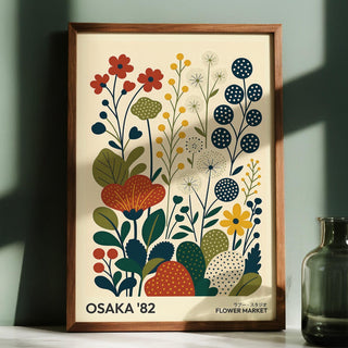 Nature Artwork framed print of minimalist stylized flowers in muted red yellow and blue with a glass vase nearby