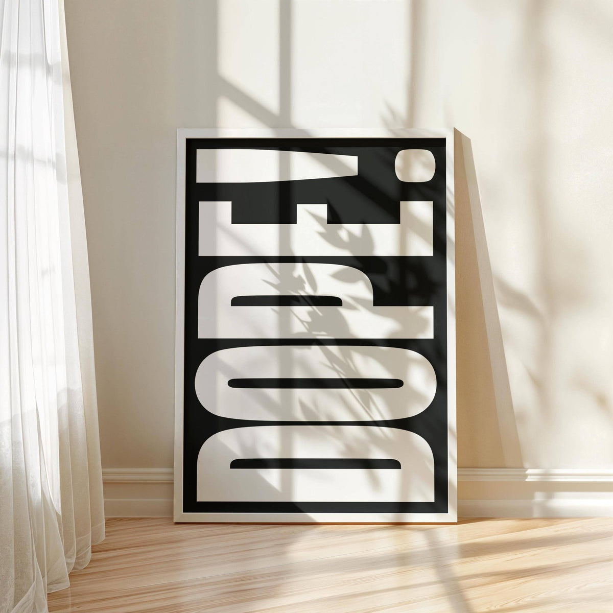 Bold Font Poster leaning on a wooden floor with dope typography in black and white and soft shadows