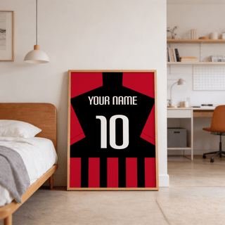 Print leaning on floor of minimalist football shirt poster in black and red stripes near a wooden bed