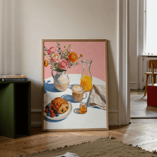 Breakfast Wall Art print leaning on floor showing an illustrated breakfast table with flowers and orange juice in a bright room